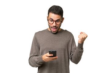 Young handsome caucasian man over isolated background surprised and sending a message