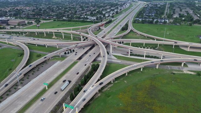 DFW metroplex master planned mixed used residential houses, apartment complex, hotels near multilevel stack interchange road junction, highway bridge Dallas North Tollway, George Bush Turnpike
