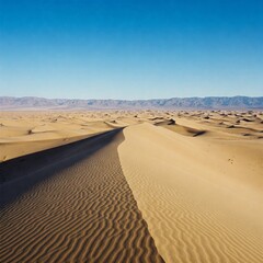 Desert sand dunes, clear blue sky background