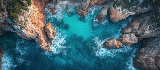 Aerial view Coastal cove, turquoise water, rocky cliffs, waves