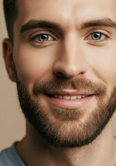 Fototapeta premium Close-up portrait of smiling young man with beard and blue eyes