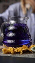 A Beautiful and Vibrant Blue Herbal Drink Served in a Glass Pitcher for Refreshment. Media