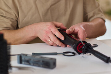 Hands of skilled workers diligently engaged in the intricate repair of mechanical devices