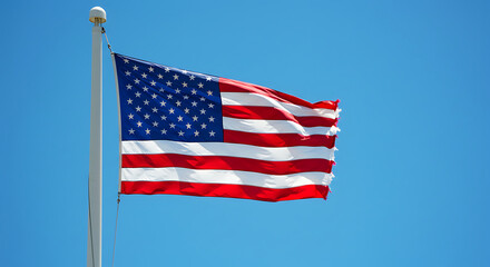 Obraz premium Waving American flag with stars and stripes against a clear blue sky, concept for patriotism, national pride and United States of America representation