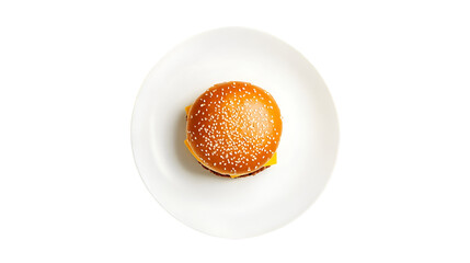Top down view of a cheeseburger with sesame seed bun on a white plate against black background