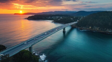 Coastal highway bridge spanning a picturesque bay at sunset.