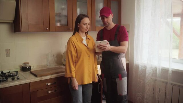 In a kitchen, a repairman discusses sink repairs while demonstrating techniques to address common plumbing issues. Viewers gain insight into effective solutions for their homes.
