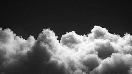 Dramatic monochrome cloudscape against a dark sky.  A close-up view of fluffy, textured clouds in shades of gray and white, contrasted with an inky black background