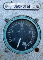 Round dark analog tachometer. The tachometer scale has a range from 0 to 20, measured in hundreds...