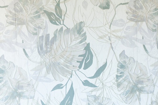 Delicate floral wallpaper with pastel blue and green leaves creating a serene, botanical aesthetic. Elegant home decor.