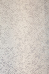 Subtle patterned off-white wall or textured surface. A blend of smooth and slightly raised sections create an understated design.