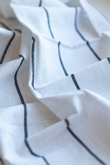 White Fabric with Black Stripes: This image captures the simplicity of white fabric adorned with sleek black stripes. Classic design in everyday materials.