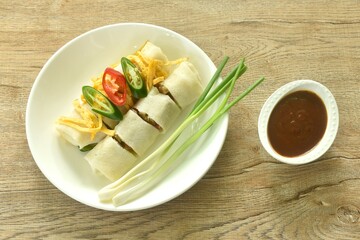 fresh Chinese spring roll made from flour wrapped tofu and pork with bean sprout dressing sweet red...