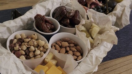 An assortment of nuts and cheeses beautifully presented in a rustic style for any occasion. Media
