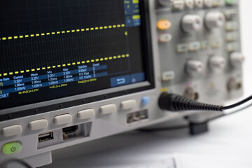 Oscilloscope displaying electronic waveform signal
