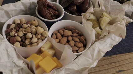 An assortment of nuts and cheeses beautifully presented in a rustic style for any occasion. Media