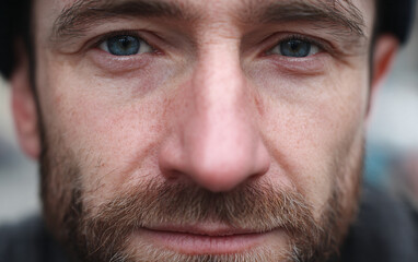 Fototapeta premium closeup portrait of middle aged man with full beard captured against neutral background, serious introspective expression emphasizing natural facial features emotional depth authenticity and character