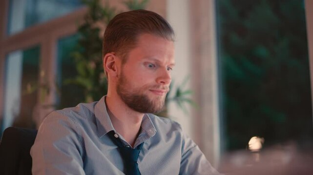 Man Working on Computer in a Modern Office Environment