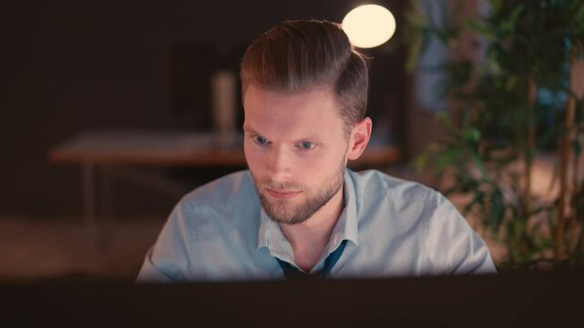 Man Working on Computer in a Modern Office Environment