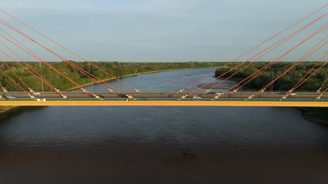 Siekierkowski bridge seen from the side, wisla river in the background, drone aerial shot on a sunset, warsaw in poland