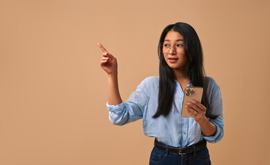 A Confident Young Woman Posing in a Casual Outfit with Style Against a Beige Background