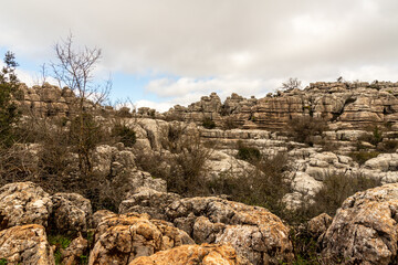 Hiking trail at El Torcal de Antequera Nature Park, Spain, on an early spring morning. Otherworldly atmosphere among breathtaking limestone formations.