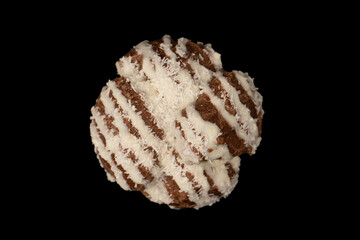 Profiteroles with coconut cream on a black background.