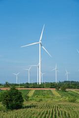 Electricity generating station, Wind turbines power generator in agricultural fields with the blue sky, Alternative Energy Windmill Farm