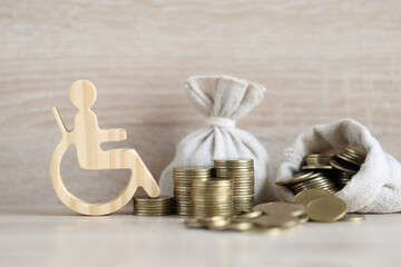 Man on wheelchair and coin money on wooden background,Save money for prepare in future and...