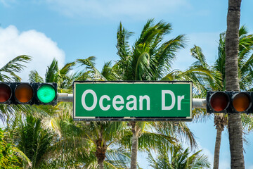 Ocean Drive street sign, traffic lights and palm trees in Miami Beach, Florida