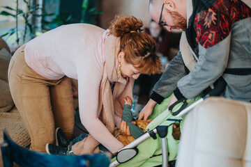 A candid moment of parents attending to their young child, ensuring safety and comfort in a stroller, captured in a cozy indoor environment with warm lighting.