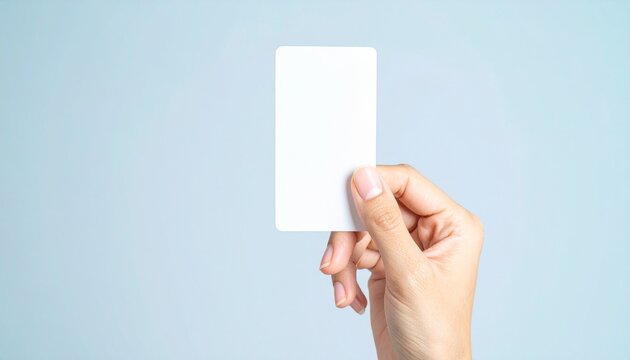 a hand holding a blank business card. It's a clean, modern shot, perfect for adding your own text or logo