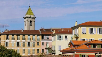 Obraz premium Colorful buildings and church tower in nice, France. Action