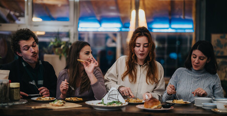 A gathering of close friends savoring tasty dishes at a warmly lit restaurant counter.