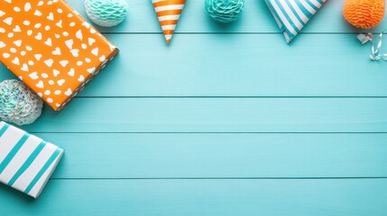 Fototapeta premium Colorful party decorations and gifts on a blue wooden background with space in the center.