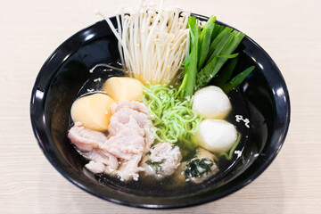 A bowl of noodle featuring a variety of colorful and fresh ingredients.