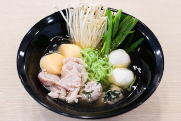 A bowl of noodle featuring a variety of colorful and fresh ingredients.