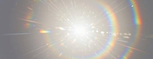 A central light source emits powerful rays and prominent circular rainbow lens flare with abstract ethereal effect, scattered light particles on transparent background
