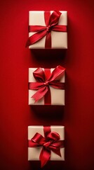 Elegant gift boxes wrapped with red satin ribbons and bows arranged vertically on a vibrant red background perfect for celebrations and festive occasions