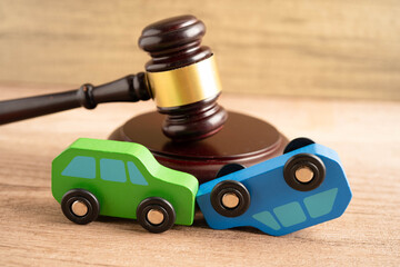 Car accident lawsuit and insurance, Judge hammer with car model.