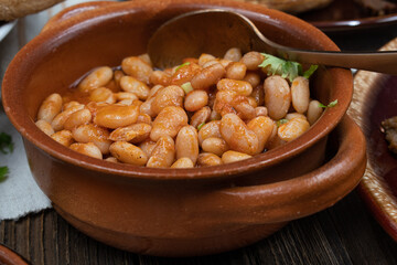 Spicy beans in small clay dish