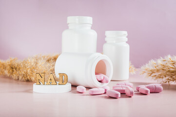 Nicotinamide adenine dinucleotide anti-aging pills and bottles on the table