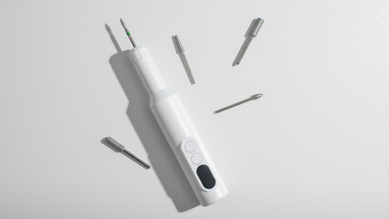 Electric screwdriver with interchangeable bits on white background, DIY craftsmanship tools, home improvement, Father's Day gift idea