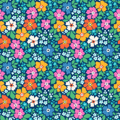 Beautiful floral pattern in small trendy flowers. Small colorful bright flowers. Dark blue background. Ditsy print. Floral seamless background. Liberty template for fashion prints. Stock pattern.