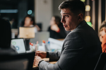 Business person deeply engaged in strategic discussion, working late into the night in a modern...