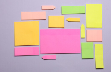 Various blank paper multicolored stickers. Sticky note collection on gray background