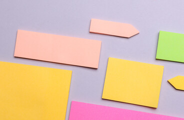 Various blank paper multicolored stickers. Sticky note collection on gray background