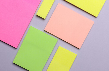 Various blank paper multicolored stickers. Sticky note collection on gray background