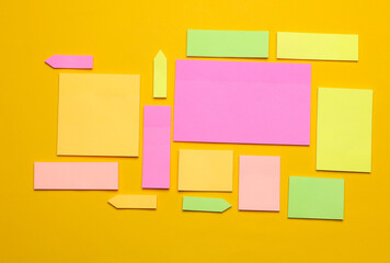Various blank paper multicolored stickers. Sticky note collection on yellow background