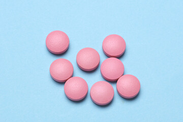 Pink pills on a blue background
